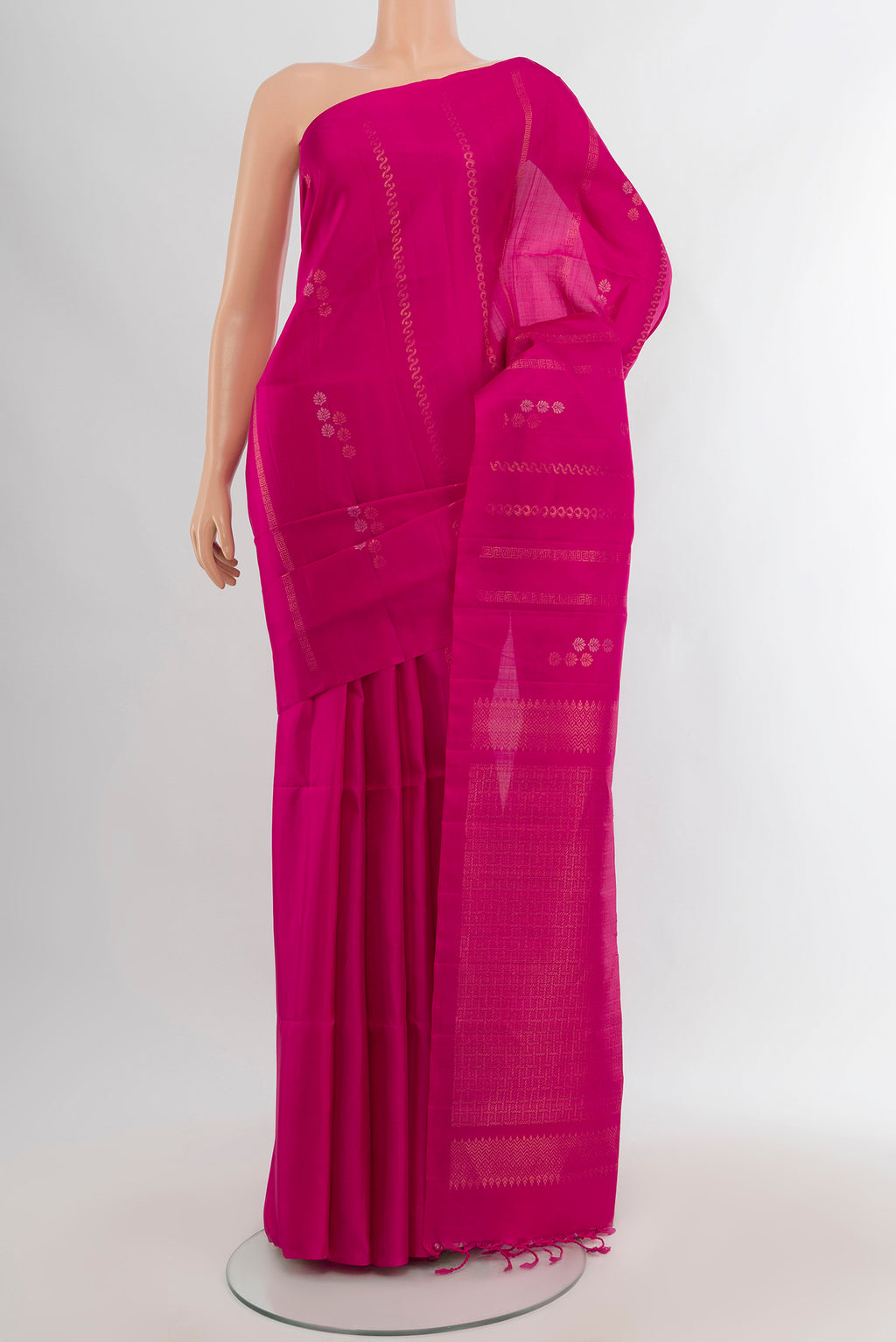 Rani Pink Soft Silk Saree with Zari Butta on the body and Without Border.  displayed on a mannequin
