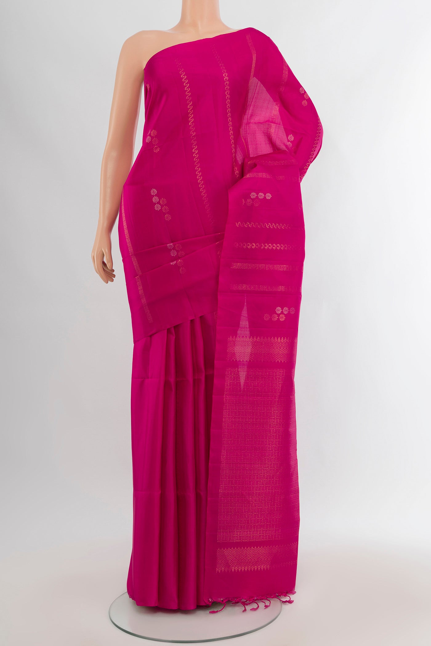 Rani Pink Soft Silk Saree with Zari Butta on the body and Without Border.  displayed on a mannequin