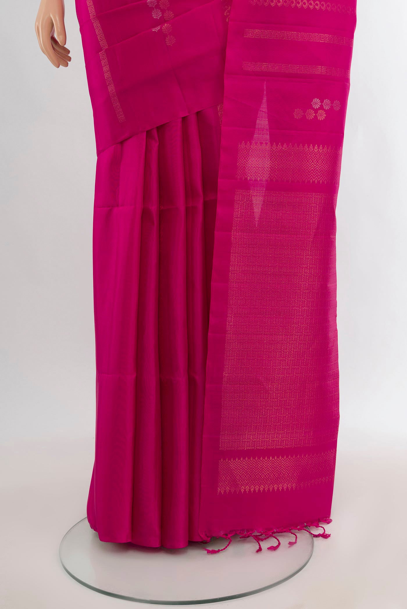 Pleats and pallu of Rani Pink Soft Silk Saree with Zari Butta on the body and Without Border. 