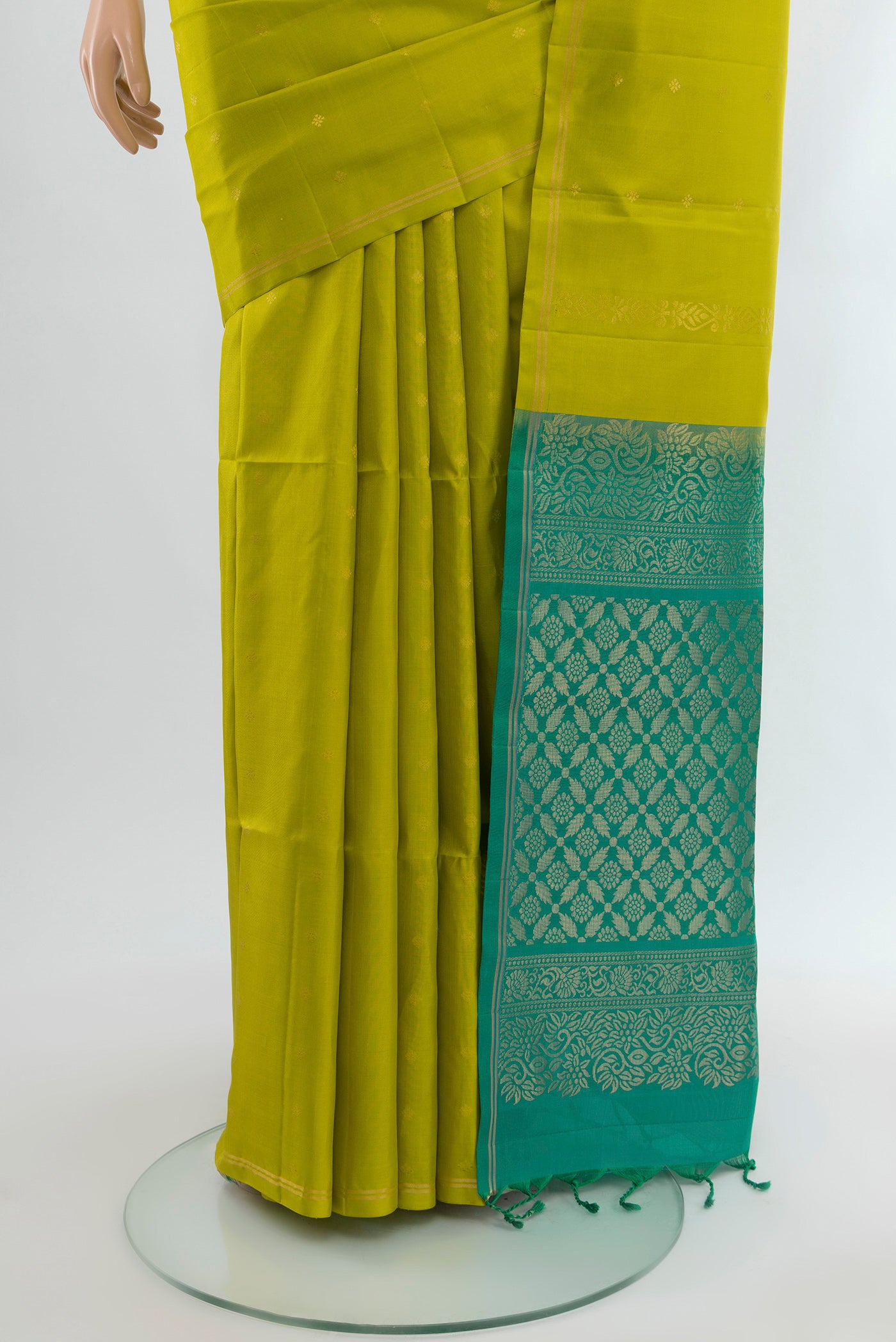 Pleats and pallu of Parrot Green Soft Silk Saree with Zari Butta on the body and Without Border. 