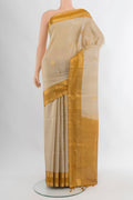 Beige Soft Silk Saree with Zari Butta on the body and Zari Border.  displayed on a mannequin