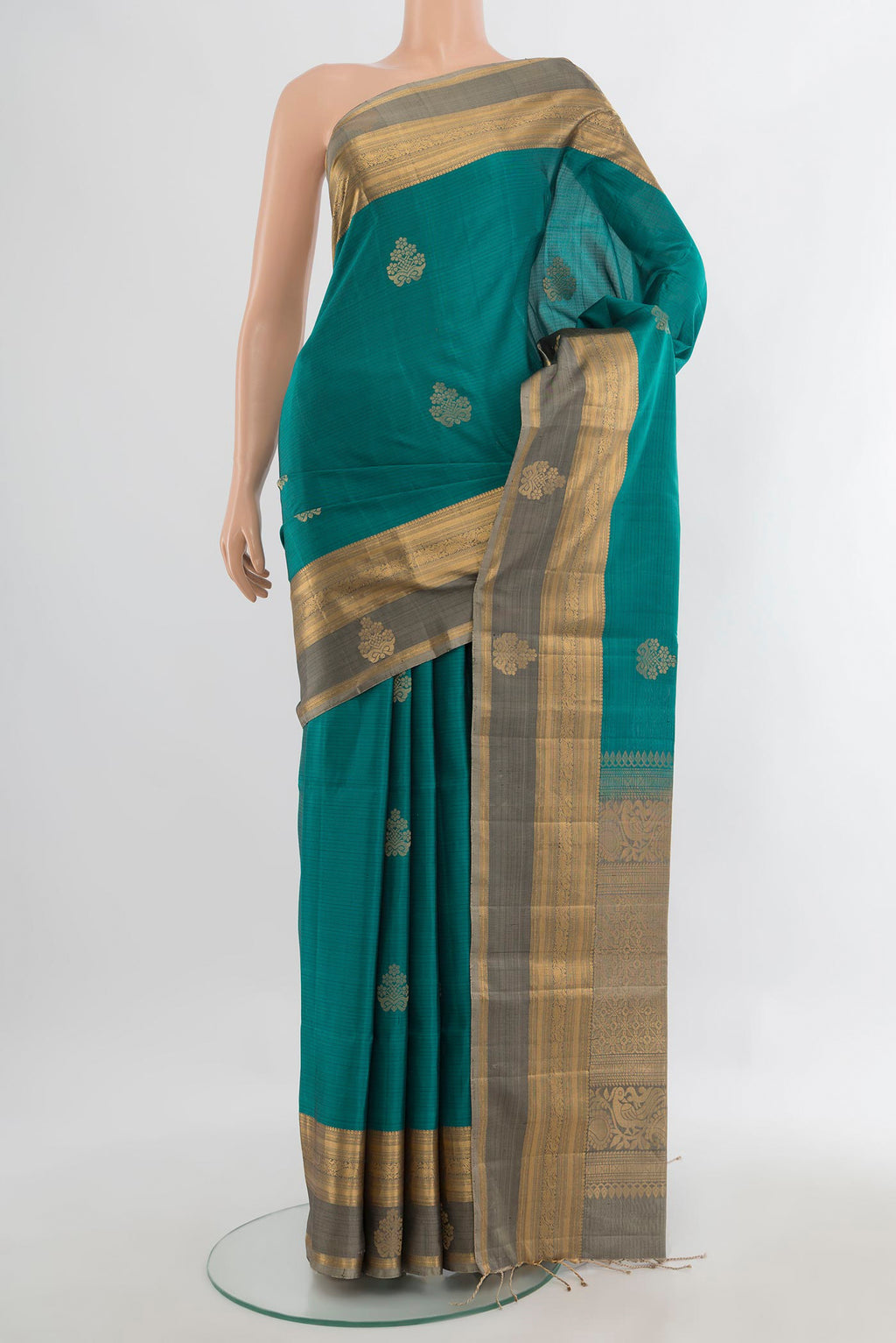Pure Silk Teal Soft Saree with Zari Butta on the body and Zari Border.  displayed on a mannequin