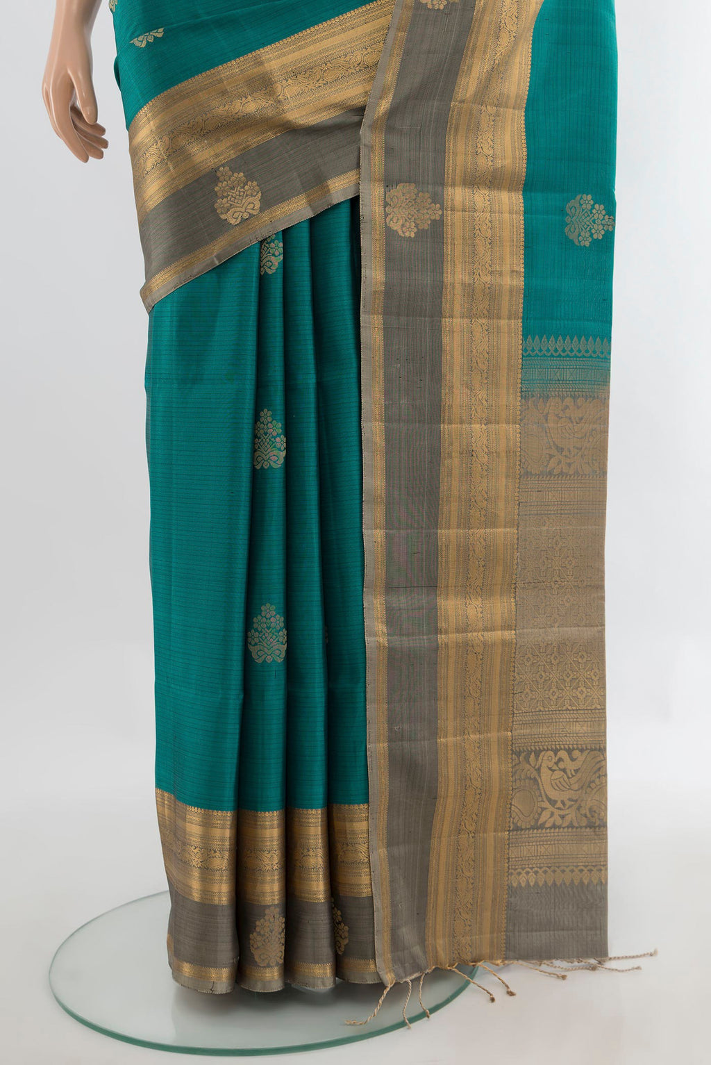 Pleats and pallu of Pure Silk Teal Soft Saree with Zari Butta on the body and Zari Border. 