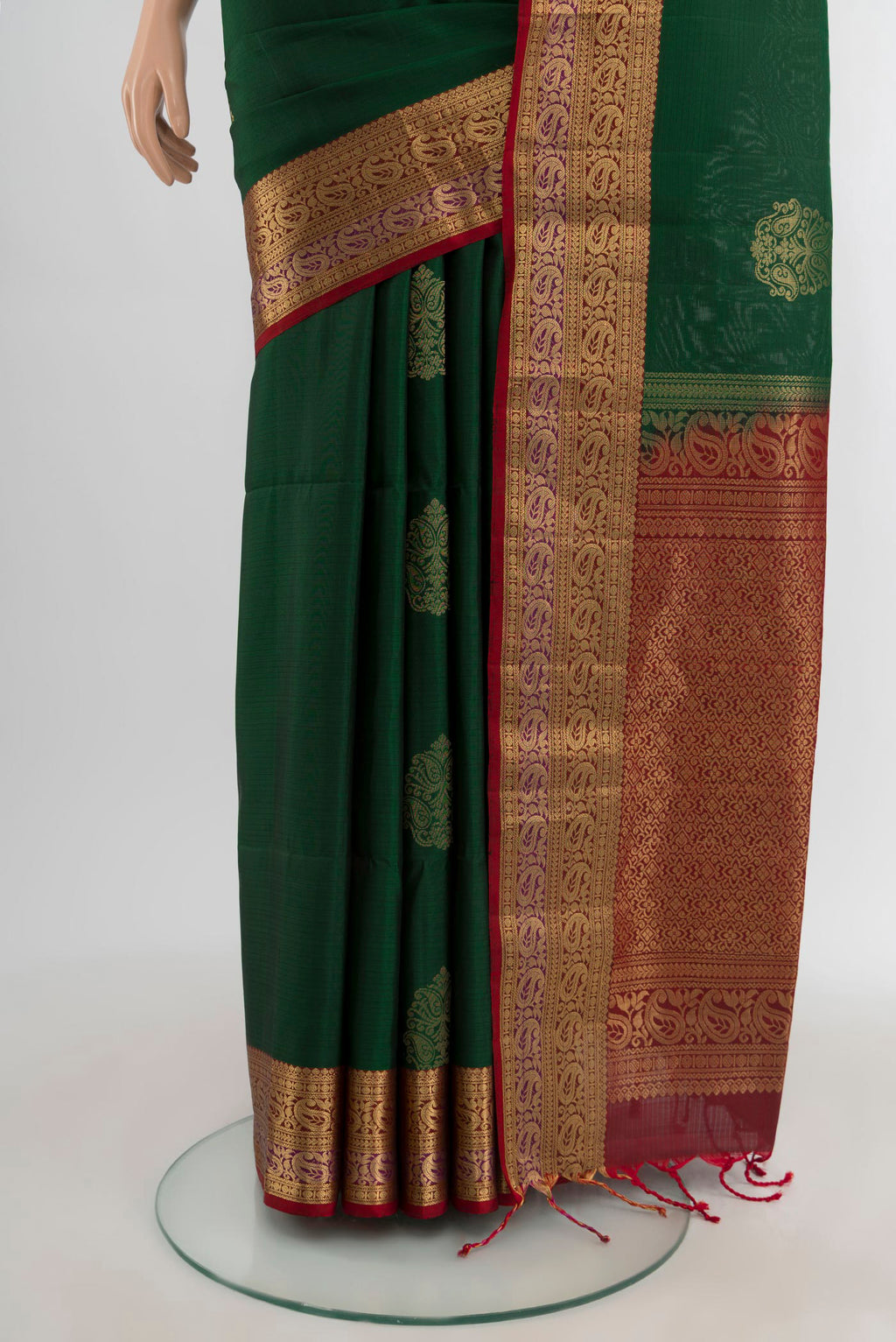 Pleats and pallu of Bottle Green Soft Silk Saree with Zari Butta on the body and Zari Border. 