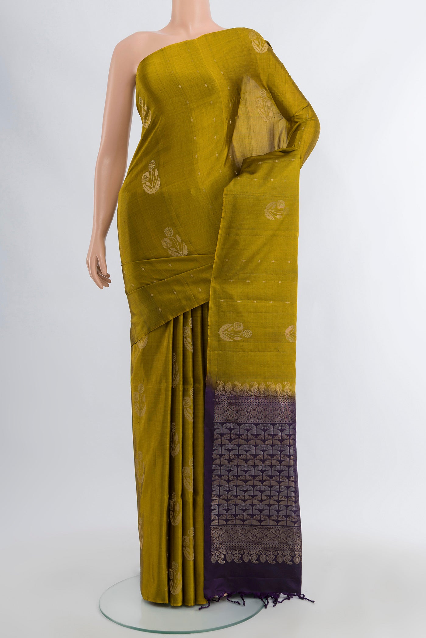 Mehandi Green Soft Silk Saree with Zari Butta on the body and Without Border.  displayed on a mannequin