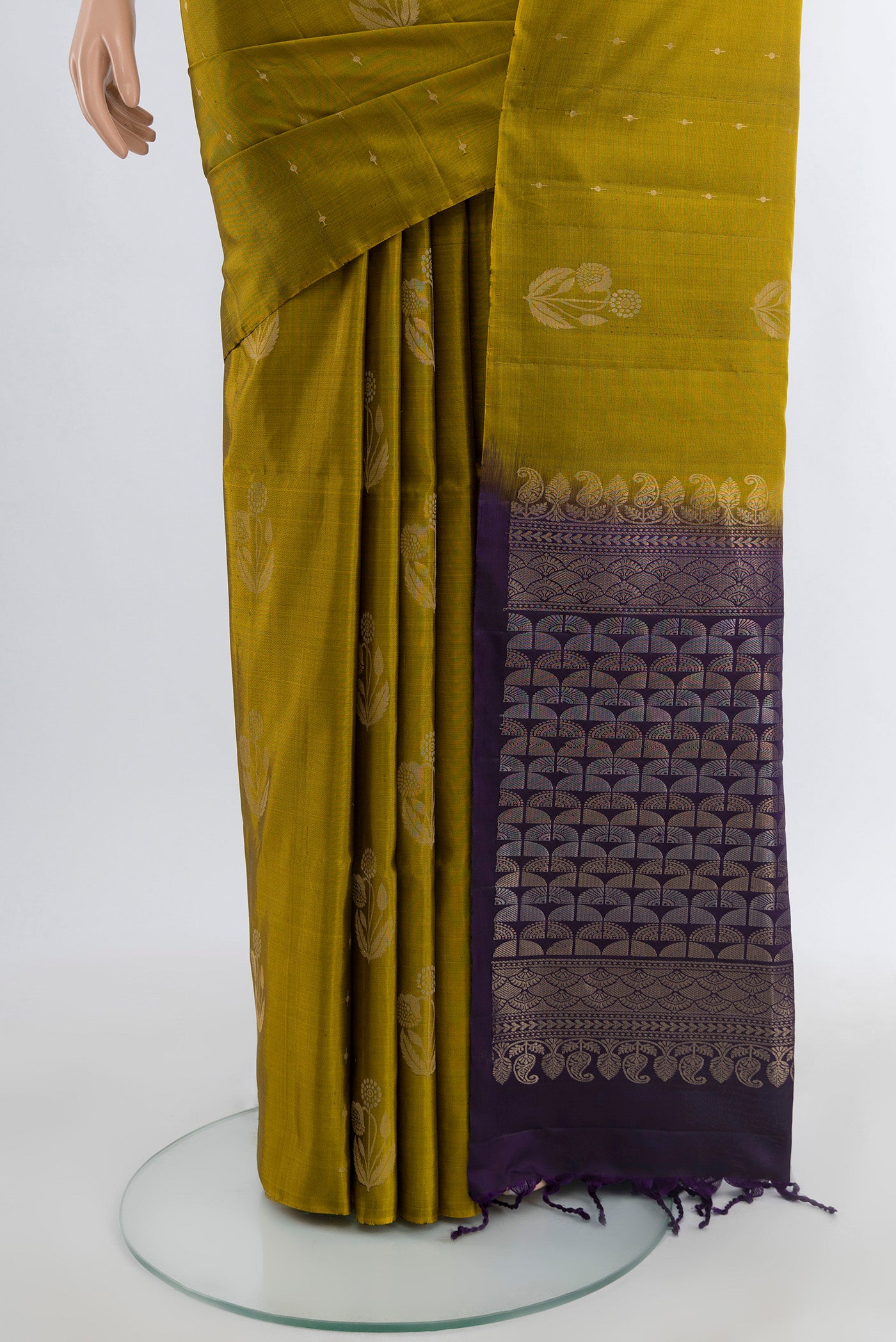 Pleats and pallu of Mehandi Green Soft Silk Saree with Zari Butta on the body and Without Border. 