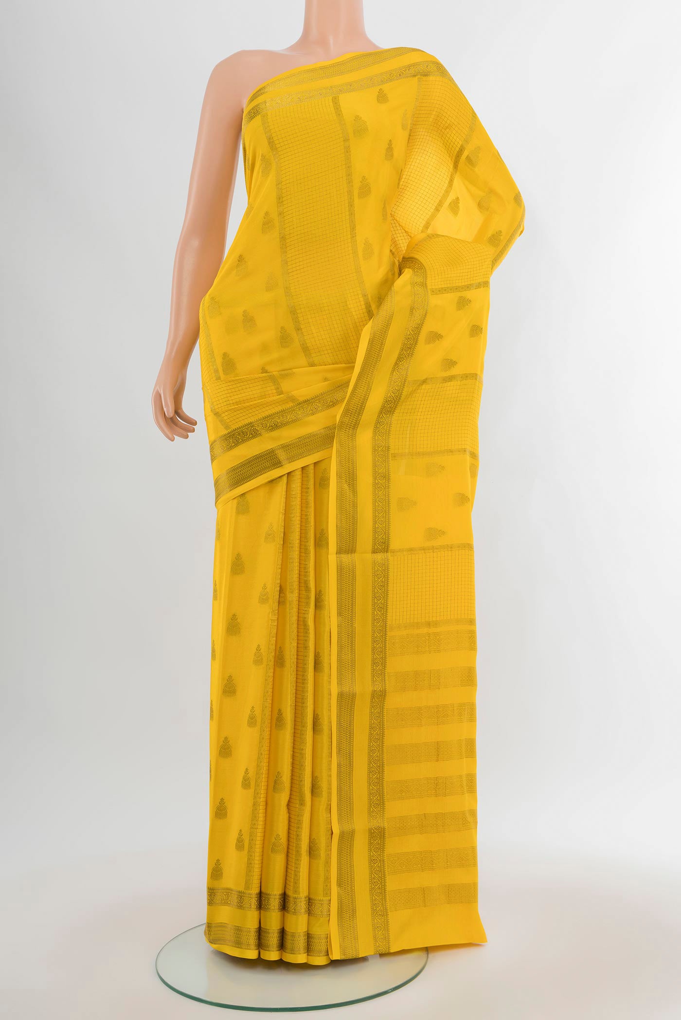 Yellow Mysore Crepe Saree with Zari Butta on the body and Zari Border.  displayed on a mannequin
