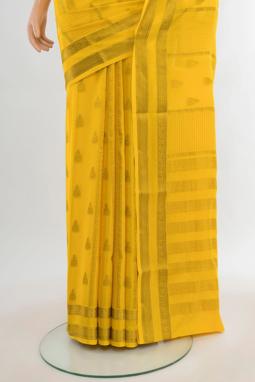 Pleats and pallu of Yellow Mysore Crepe Saree with Zari Butta on the body and Zari Border. 