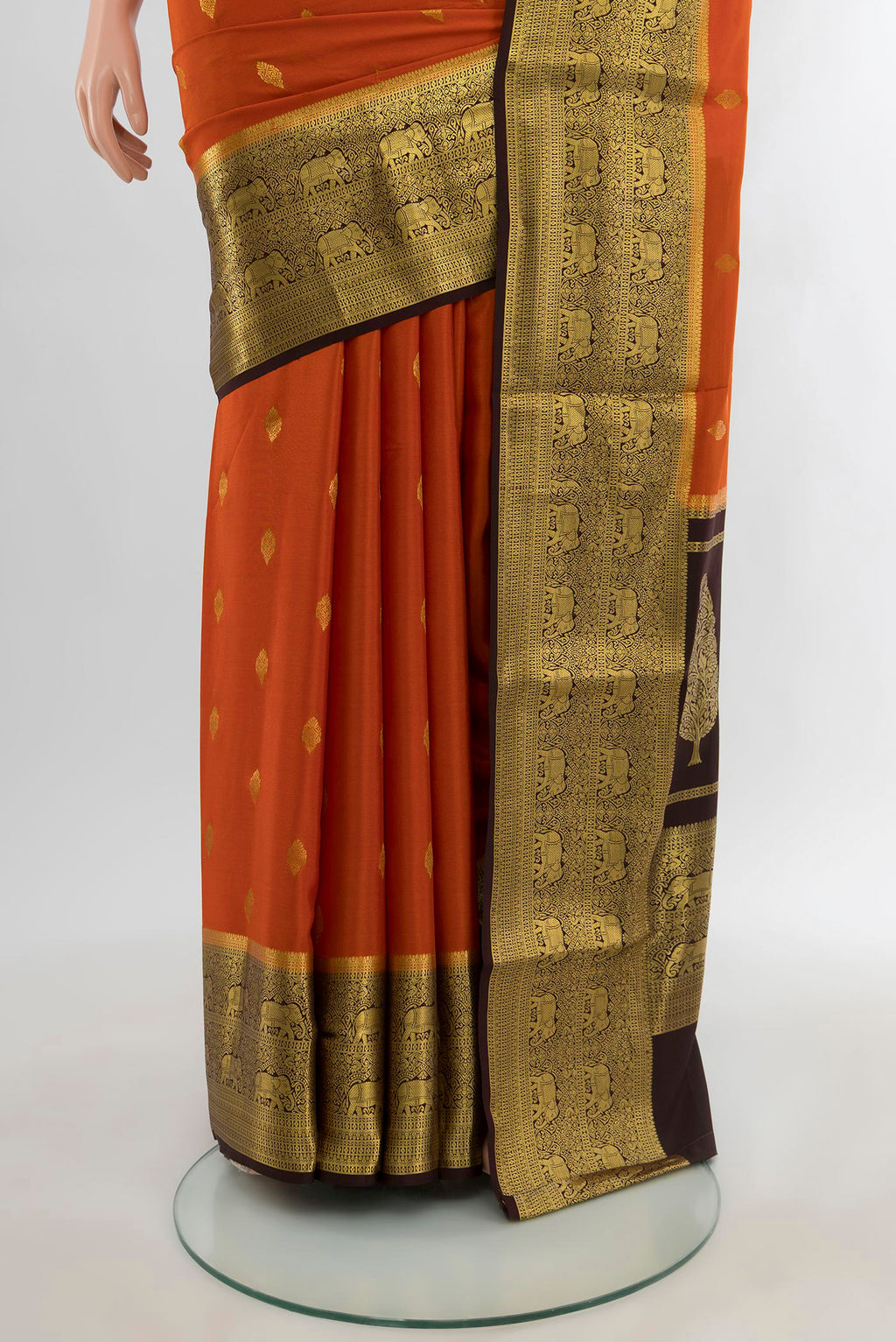 Pleats and pallu of Brick Orange Mysore Crepe Saree with Zari Butta on the body and Zari Border. 