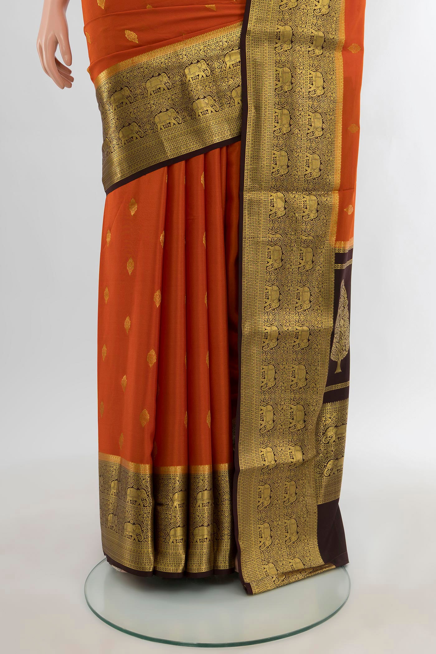 Pleats and pallu of Brick Orange Mysore Crepe Saree with Zari Butta on the body and Zari Border. 