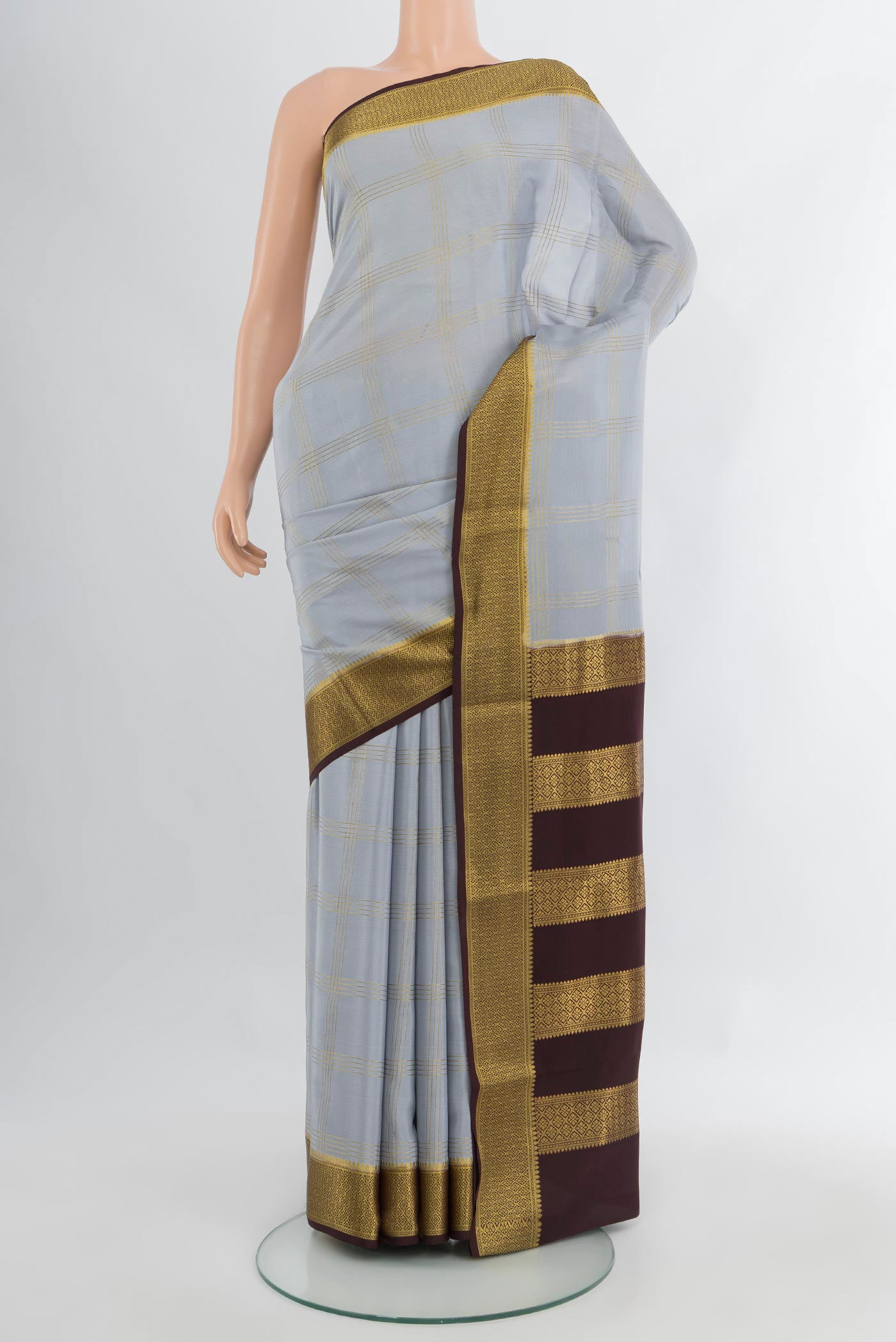 Lilac Mysore Crepe Saree with Checked design on the body and Zari Border.  displayed on a mannequin