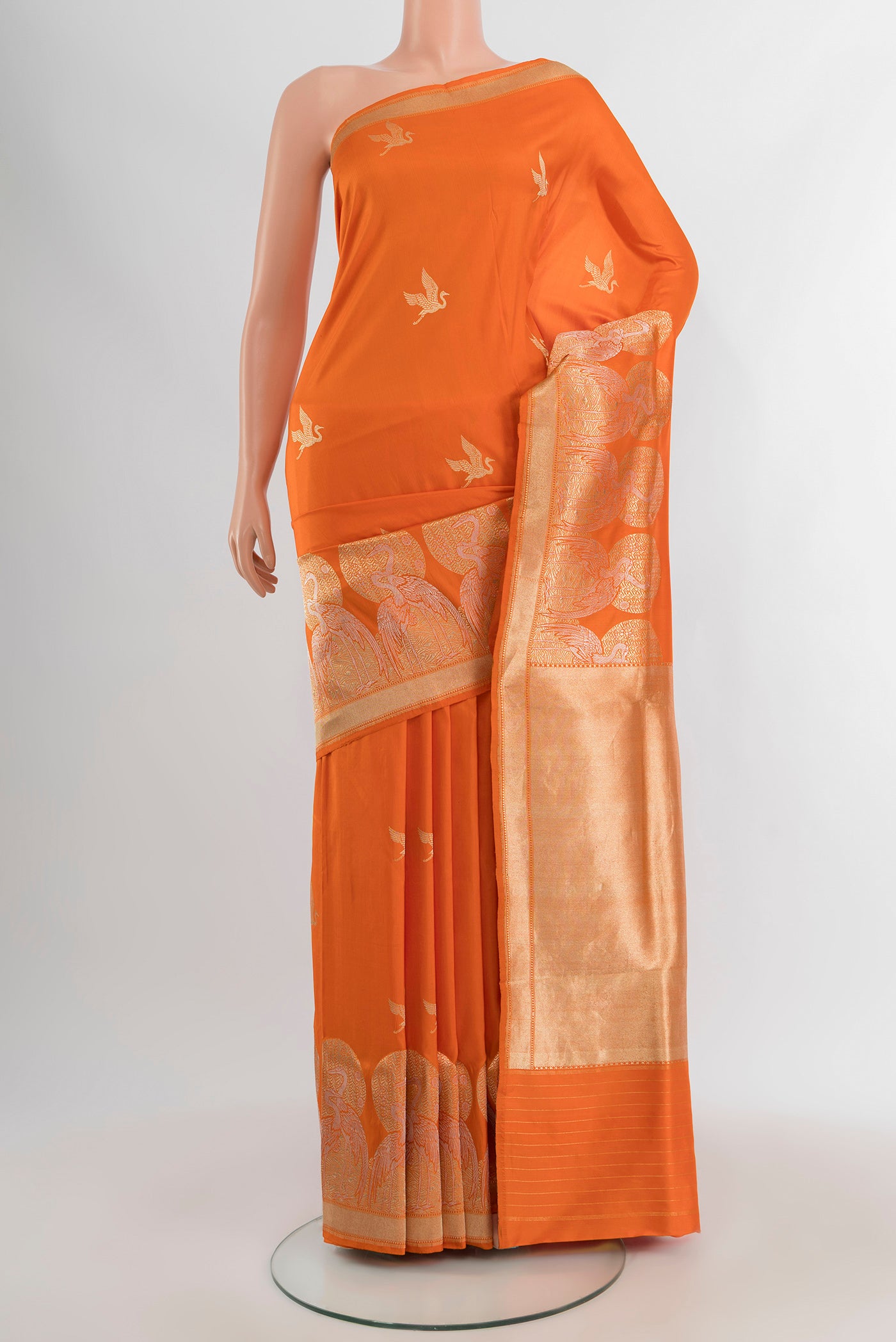 Orange Banarasi Silk Saree with Zari Butta on the body and Fancy Border.  displayed on a mannequin