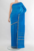 Light Blue Kanchipuram Silk Saree with Plain Body and Zari Border.  displayed on a mannequin