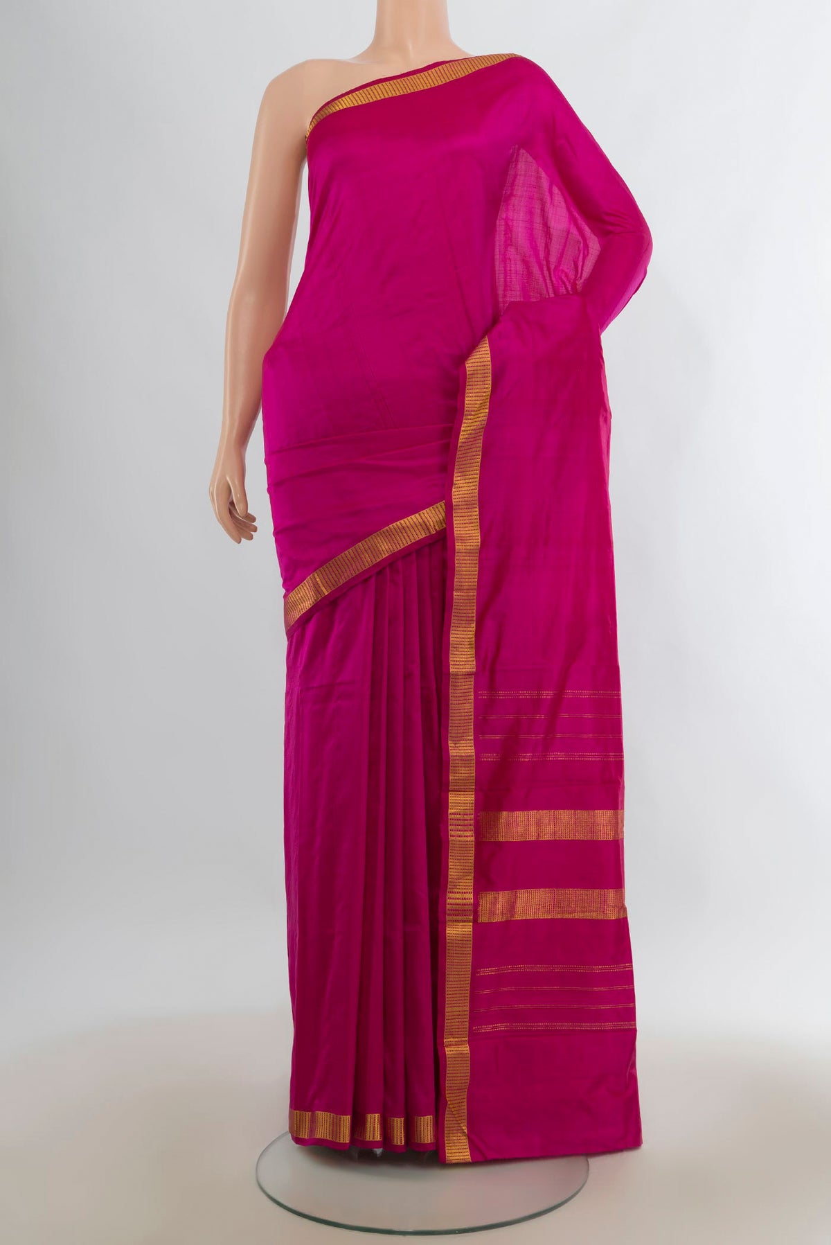 Pure Silk Rani Pink Kanchipuram Saree with Plain Body and Zari Border.  displayed on a mannequin