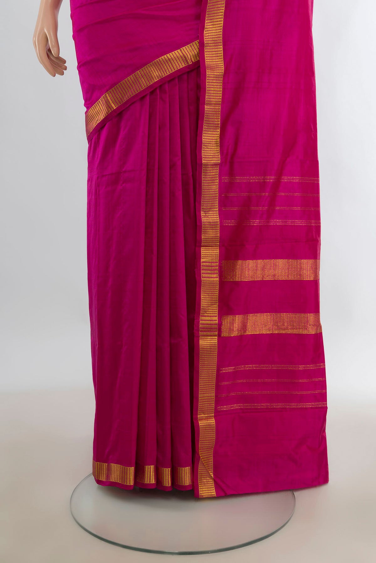 Pleats and pallu of Pure Silk Rani Pink Kanchipuram Saree with Plain Body and Zari Border. 