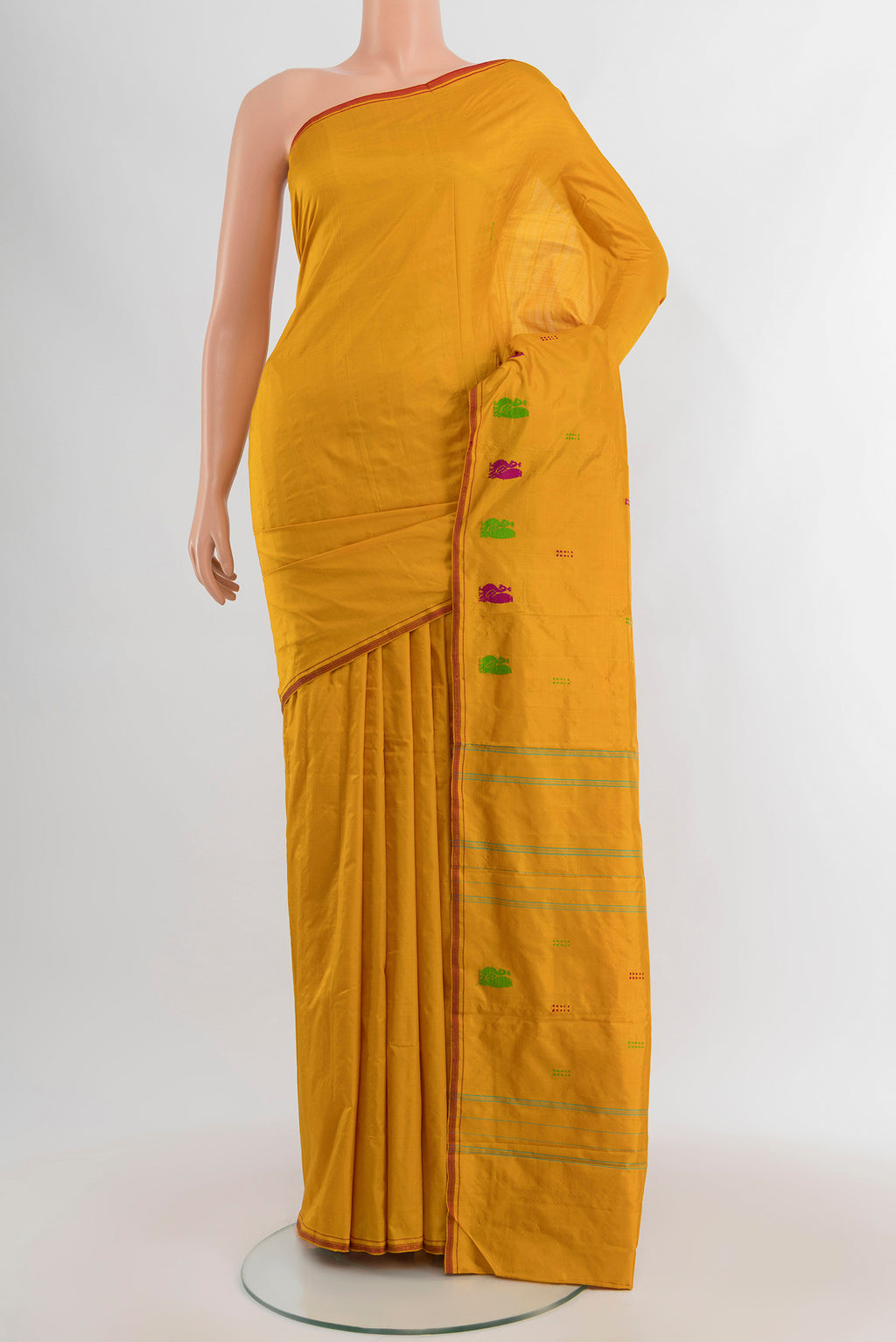 Mustard Kanchipuram Silk Saree with Plain Body and Thread Border.  displayed on a mannequin