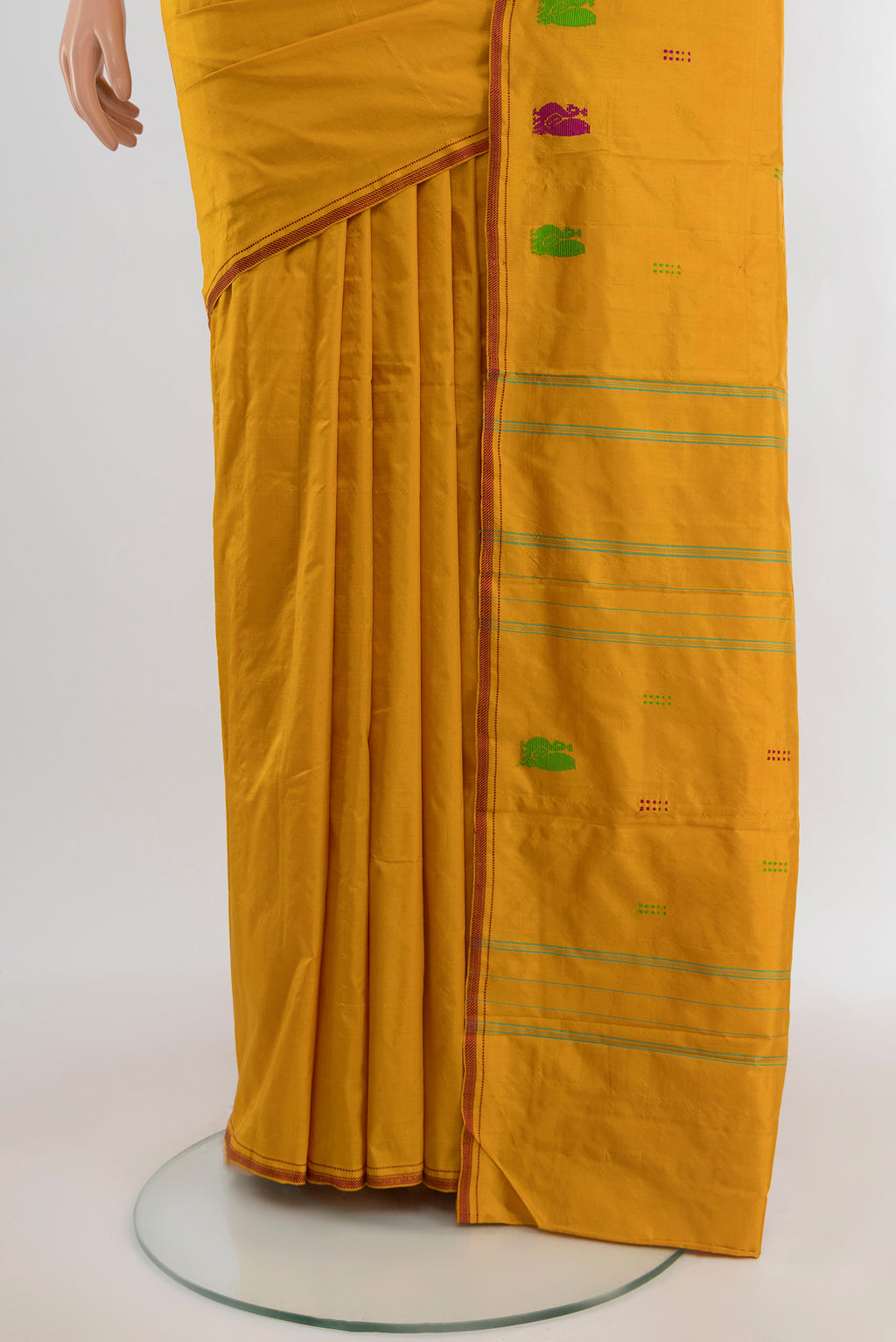 Pleats and pallu of Mustard Kanchipuram Silk Saree with Plain Body and Thread Border. 