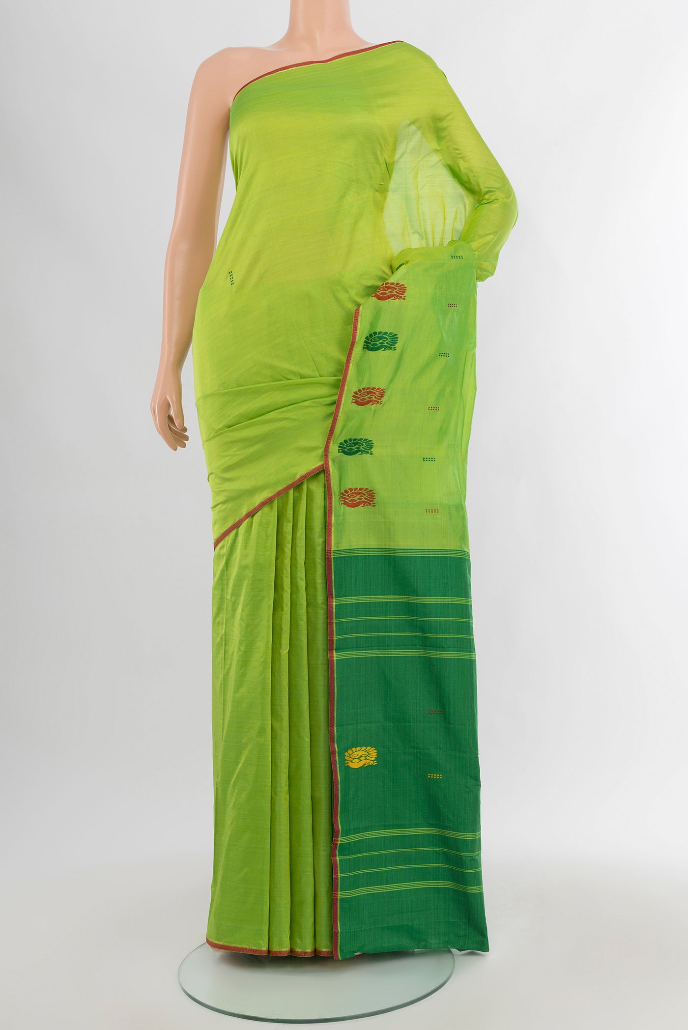 Parrot Green Kanchipuram Silk Saree with Thread Butta on the body and Thread Border.  displayed on a mannequin