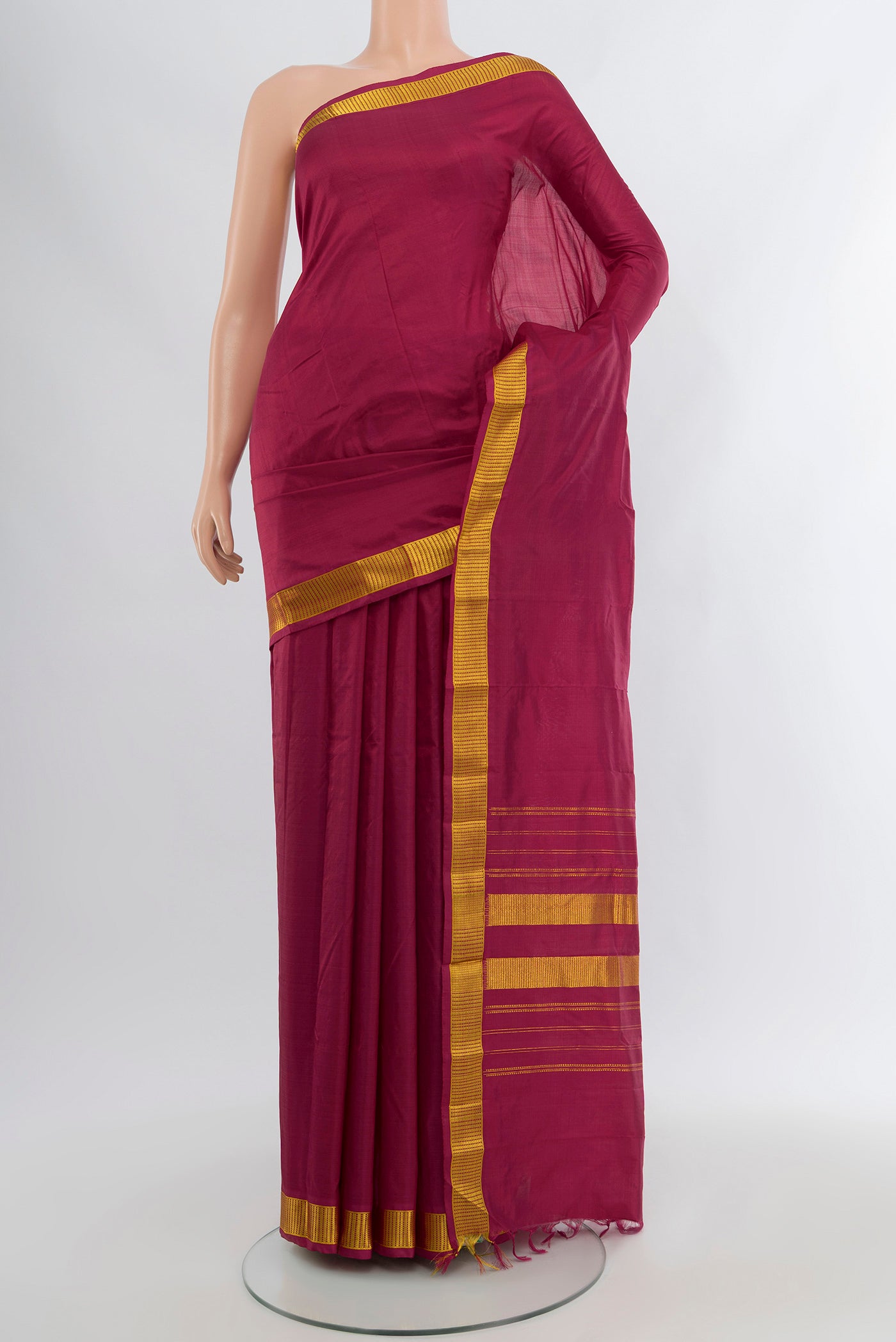 Maroon Kanjivaram Silk Saree with Plain Body and Zari Border.  displayed on a mannequin
