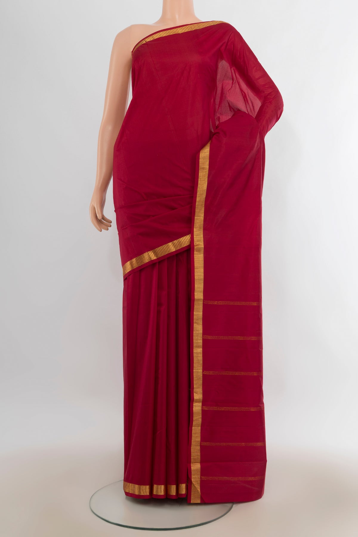 Pure Silk Deep Red Kanjivaram Saree with Plain Body and Zari Border.  displayed on a mannequin