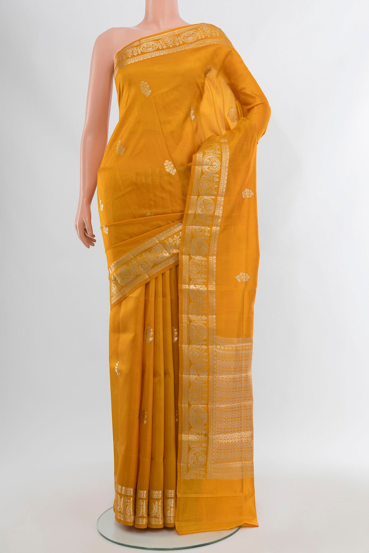 Mustard Banarasi Raw Silk Saree with Zari Butta on the body and Zari Border.  displayed on a mannequin