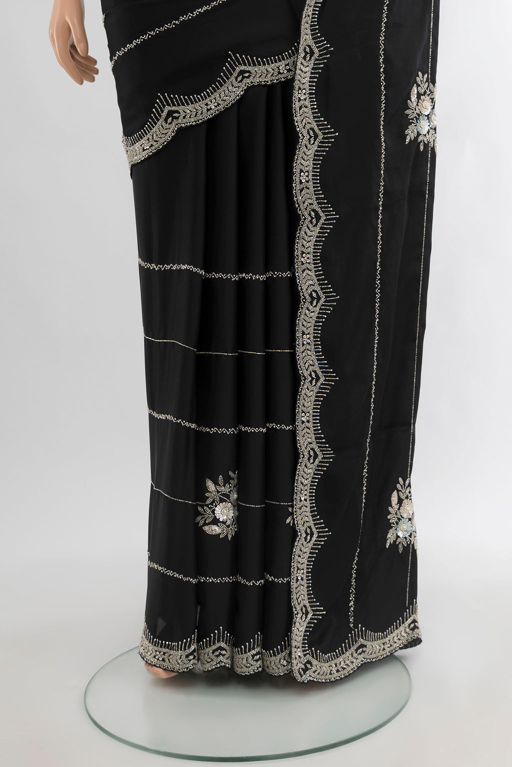 Pleats and pallu of Black Blended Crepe Saree with Embroidery on the body and Embroidery Border. 