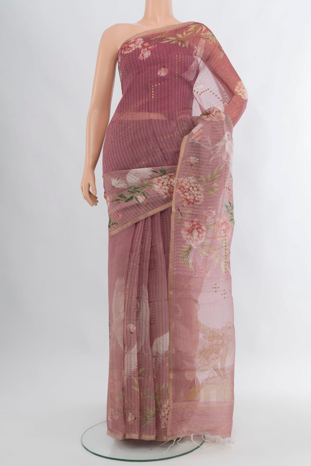 Mauve Organza Silk Saree with Floral Print on the body and Zari Border.  displayed on a mannequin