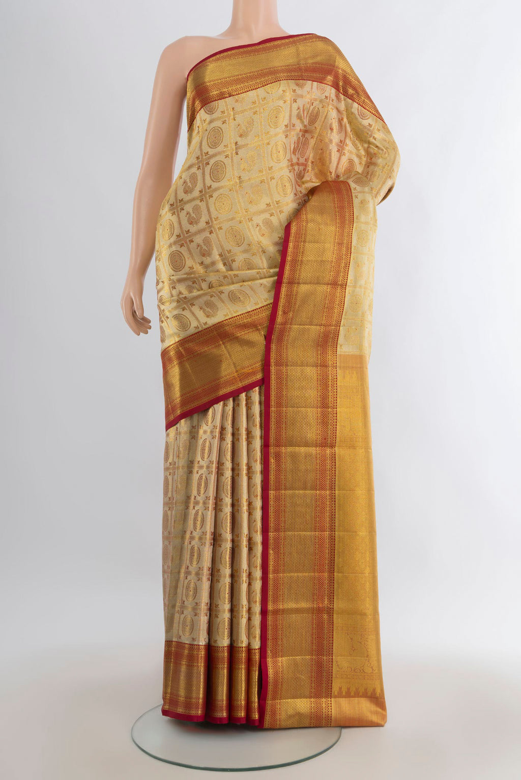 Golden Kanjivaram Tissue Saree with Zari Brocade on the body and Zari Border.  displayed on a mannequin