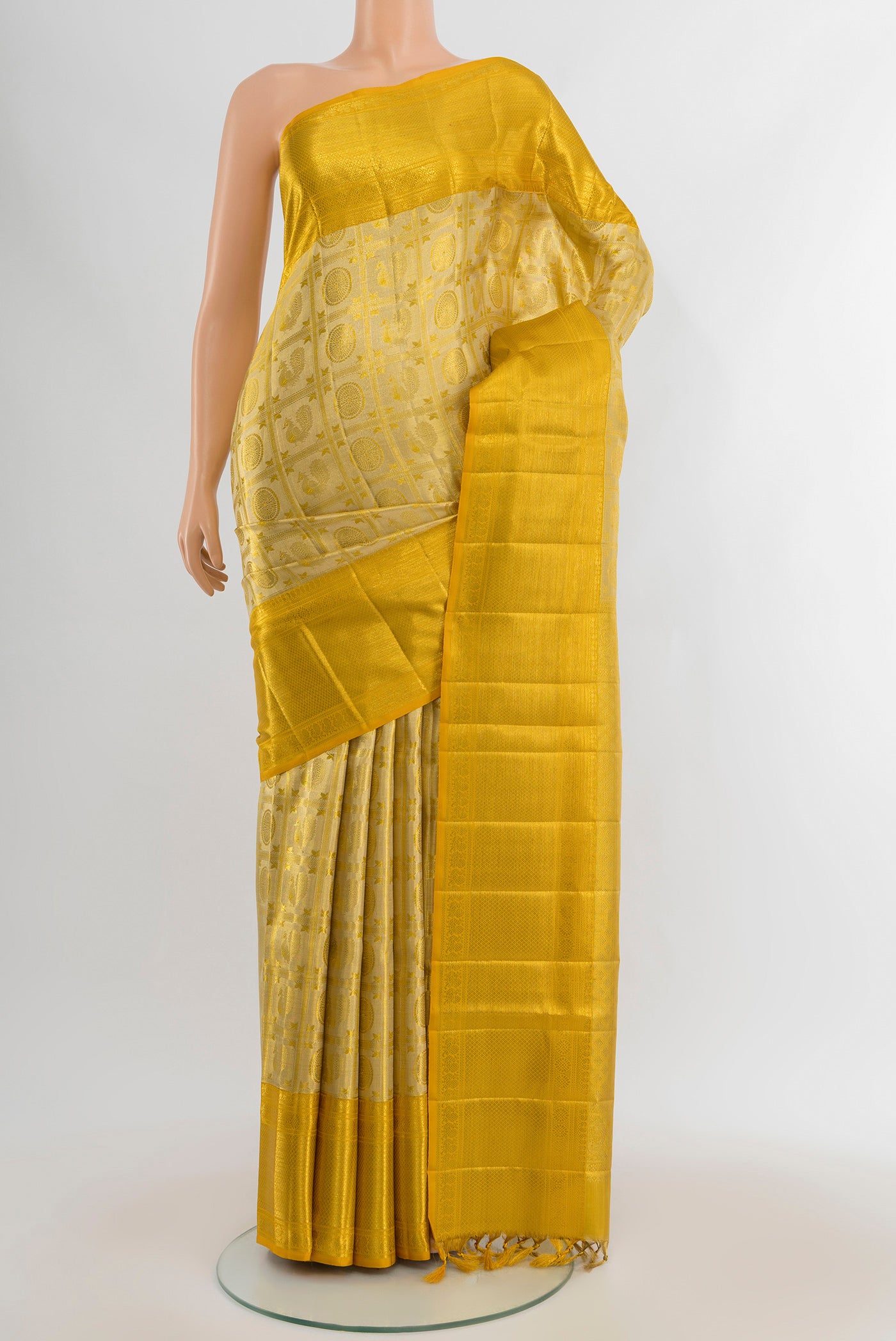 Golden Kanjivaram Tissue Silk Saree with Zari Brocade on the body and Zari Border.  displayed on a mannequin