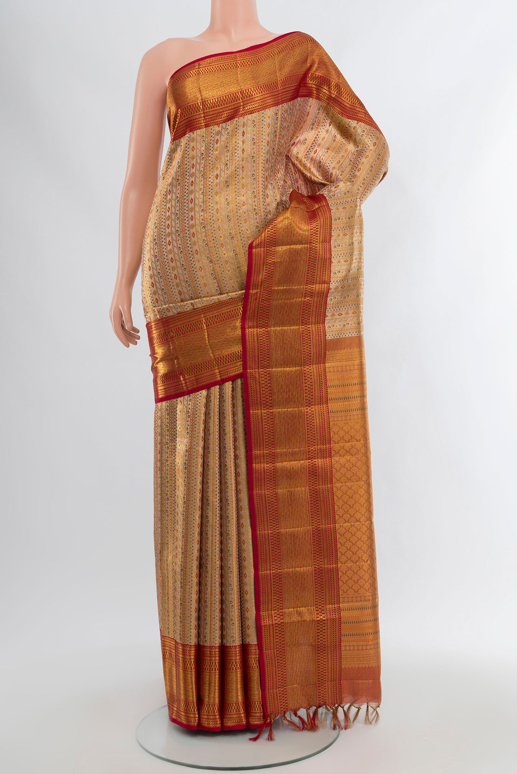 Golden Kanjivaram Tissue Silk Saree with Zari Brocade on the body and Zari Border.  displayed on a mannequin