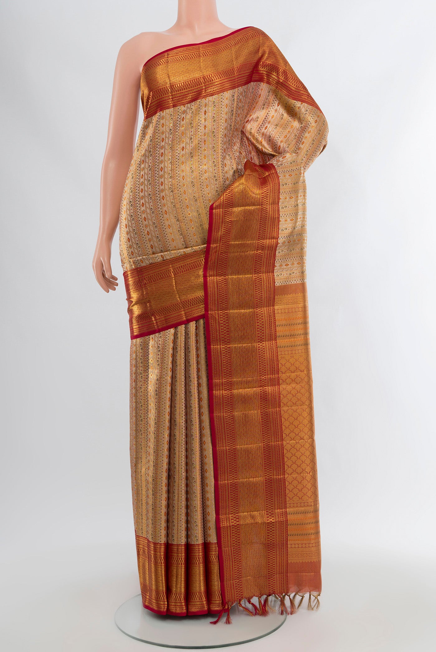 Golden Kanjivaram Tissue Silk Saree with Zari Brocade on the body and Zari Border.  displayed on a mannequin