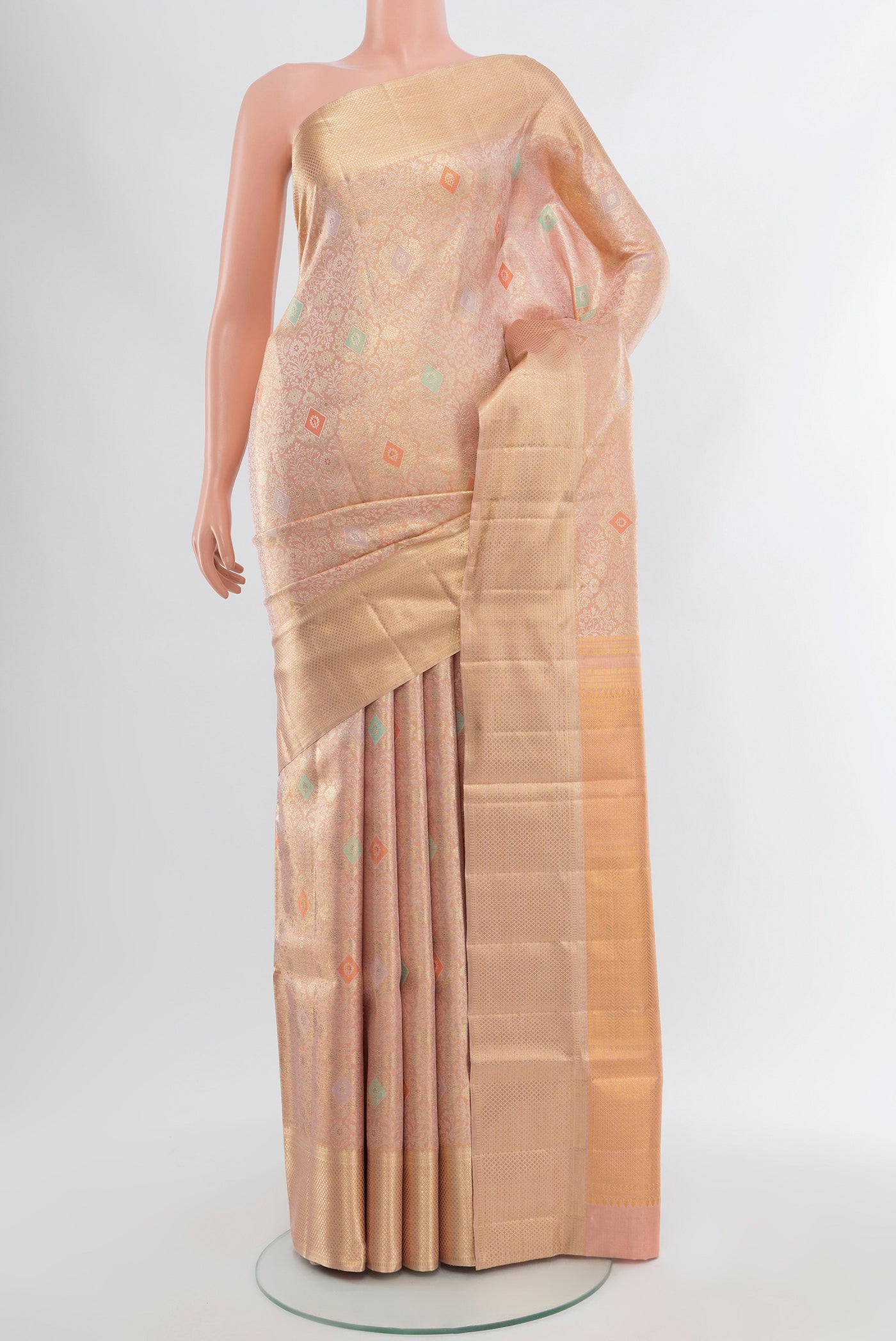 Peach Kanjivaram Silk Saree with Zari Brocade on the body and Zari Border.  displayed on a mannequin