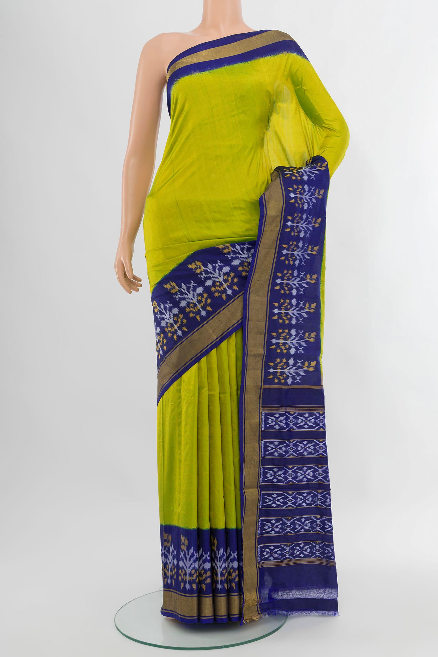 Parrot Green Pochampally Silk Saree with Plain Body and Ikat Border.  displayed on a mannequin