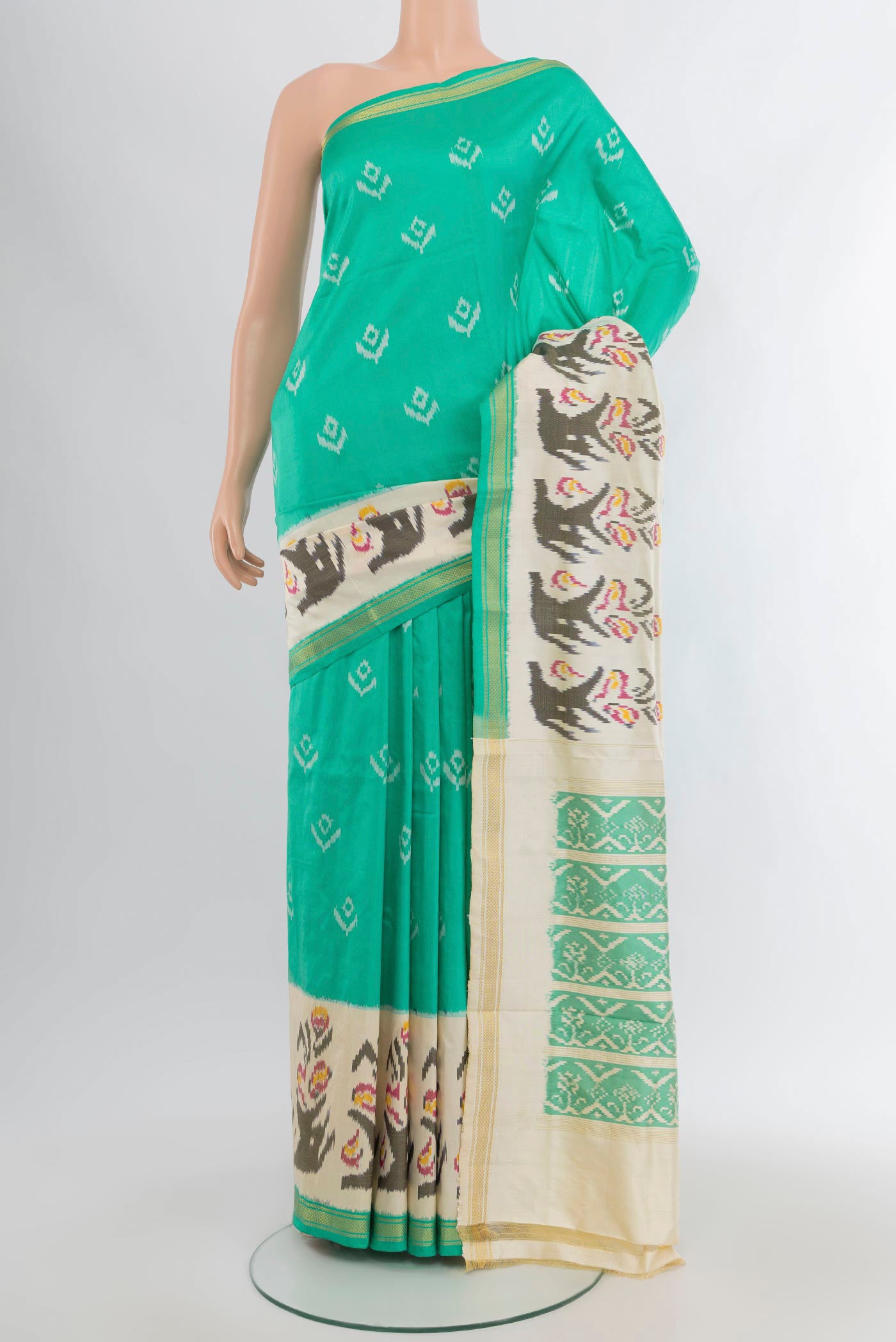 Sea Green Pochampally Silk Saree with Pure Ikat on the body and Ikat Border.  displayed on a mannequin
