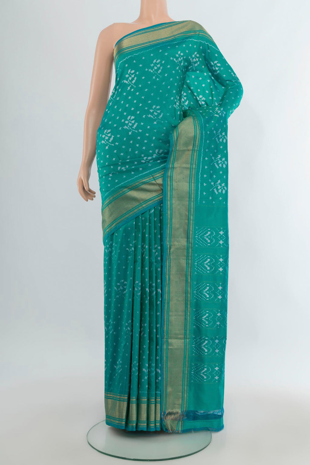 Pure Silk Sea Green Pochampally Saree with Pure Ikat on the body and Zari Border.  displayed on a mannequin
