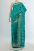 Pure Silk Sea Green Pochampally Saree with Pure Ikat on the body and Zari Border.  displayed on a mannequin