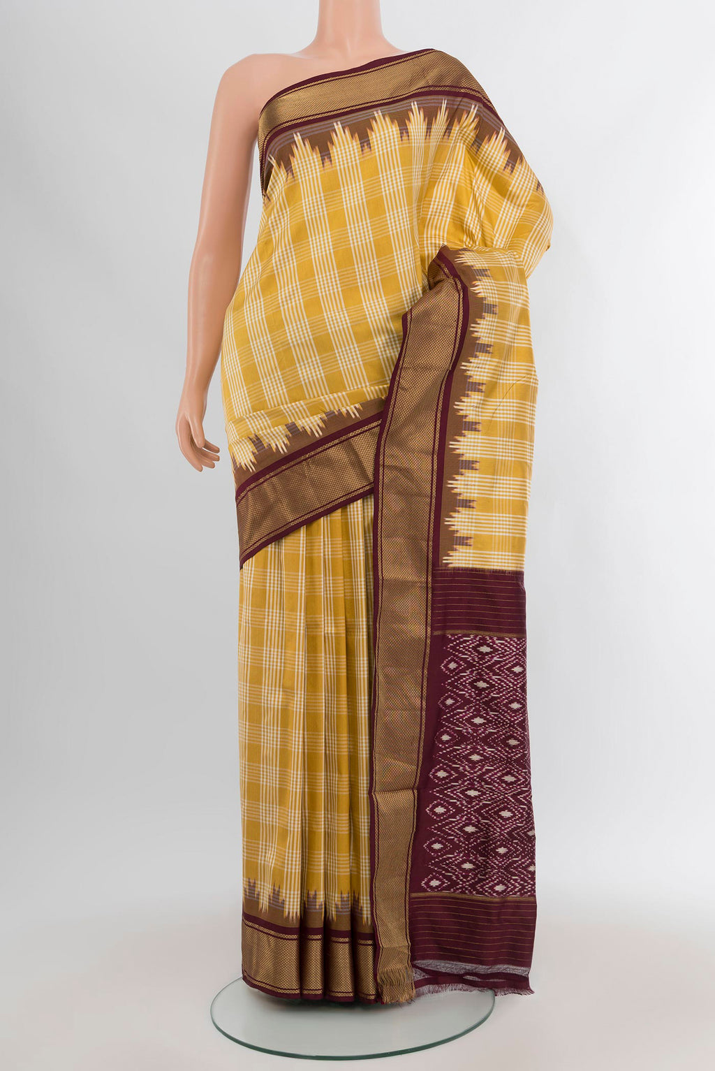 Yellow Pochampally Silk Saree with Ikat Print on the body and Zari Border.  displayed on a mannequin