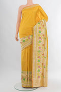 Yellow Banarasi Silk Saree with Zari Butta on the body and Zari Border.  displayed on a mannequin