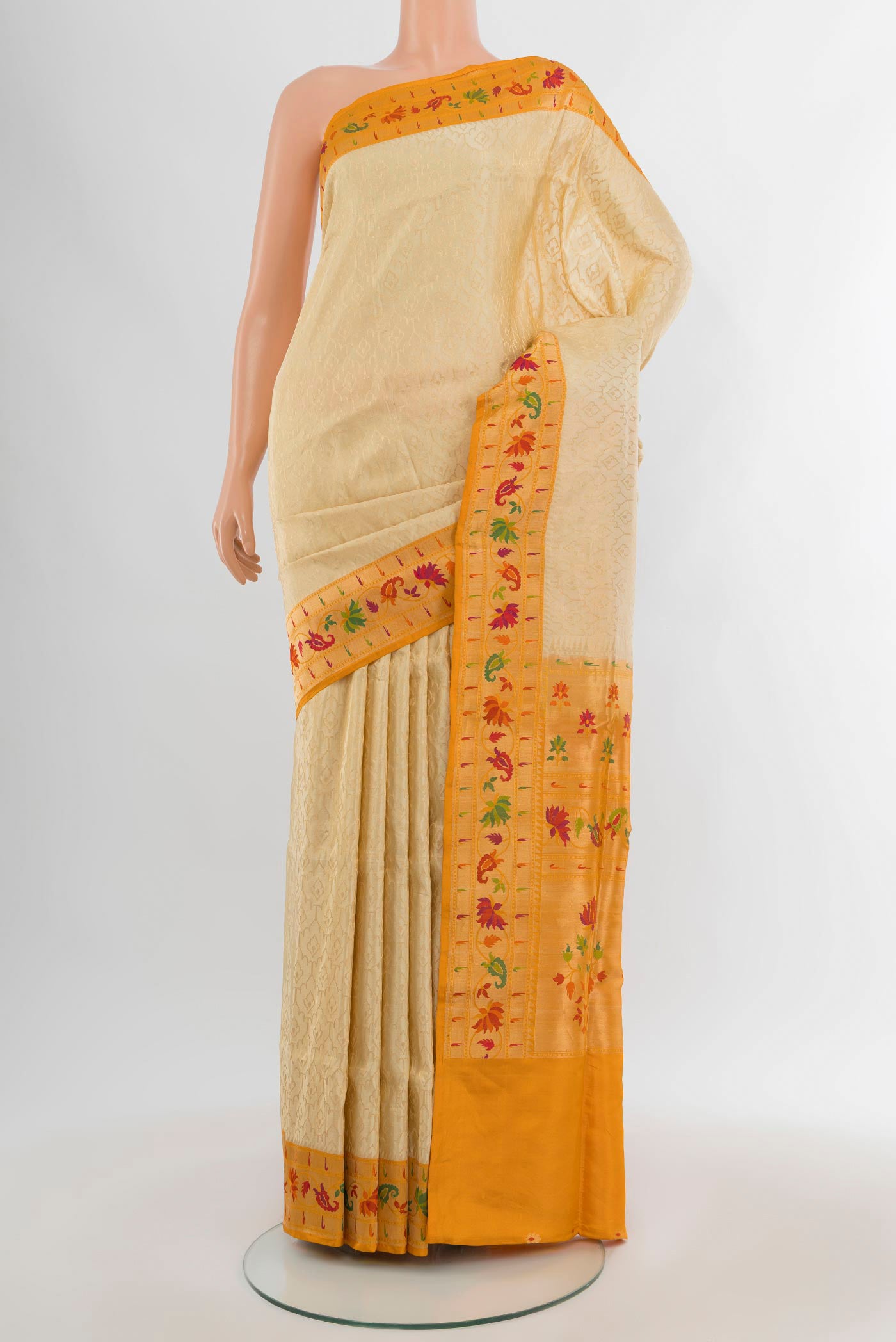 Cream Banarasi Silk Saree with Zari Brocade on the body and Paithani Border.  displayed on a mannequin