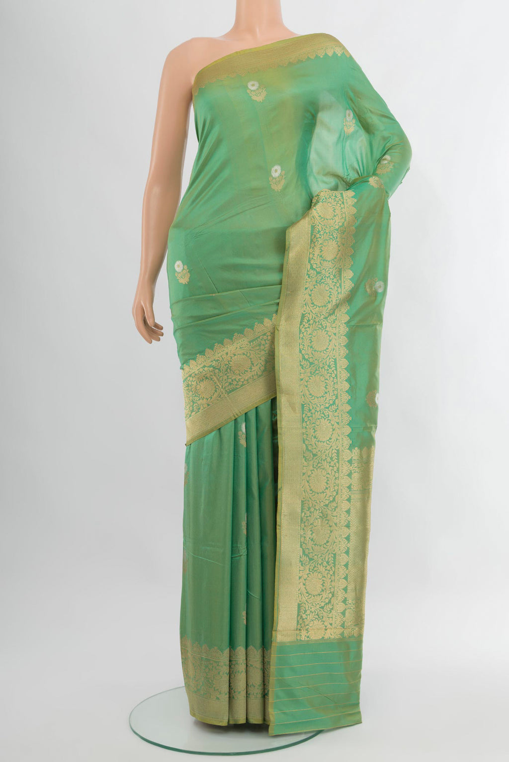 Green Banarasi Katan Silk Saree with Zari Butta on the body and Zari Border.  displayed on a mannequin