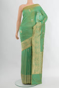 Green Banarasi Katan Silk Saree with Zari Butta on the body and Zari Border.  displayed on a mannequin