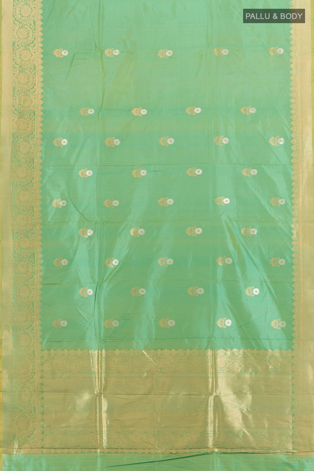 Flat view of Green Banarasi Katan Silk Saree with Zari Butta on the body and Zari Border. 