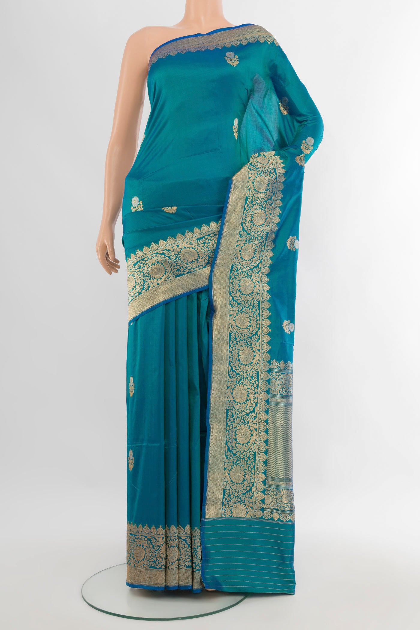 Peacock Blue Banarasi Katan Silk Saree with Zari Butta on the body and Zari Border.  displayed on a mannequin