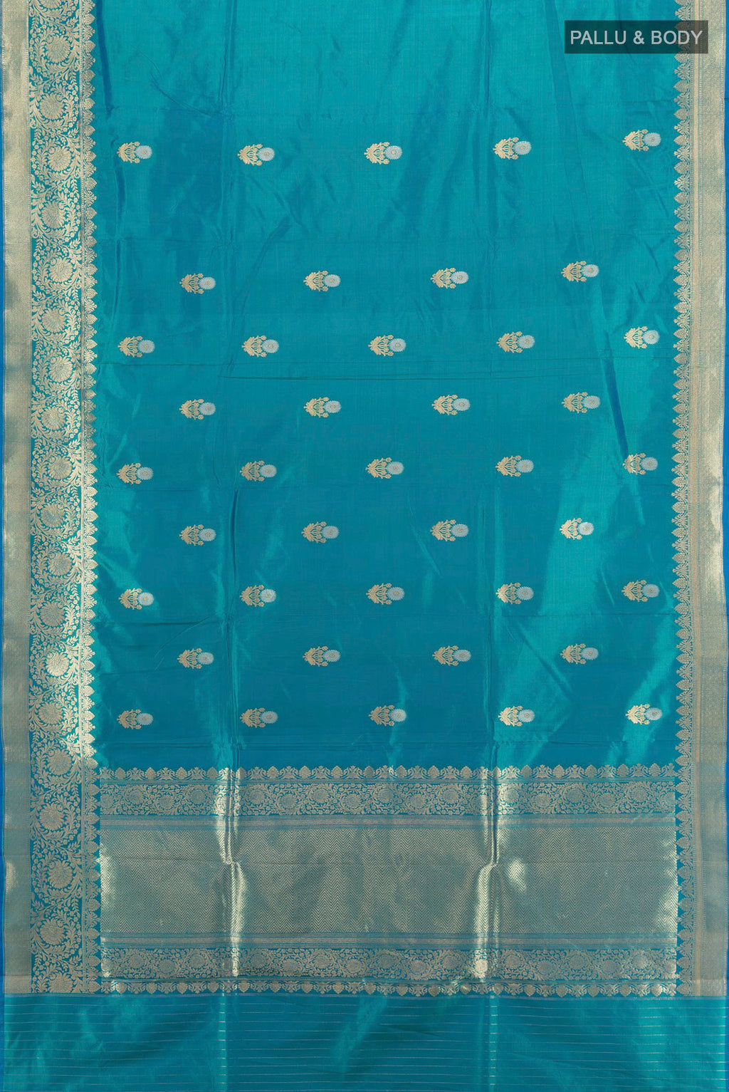 Flat view of Peacock Blue Banarasi Katan Silk Saree with Zari Butta on the body and Zari Border. 