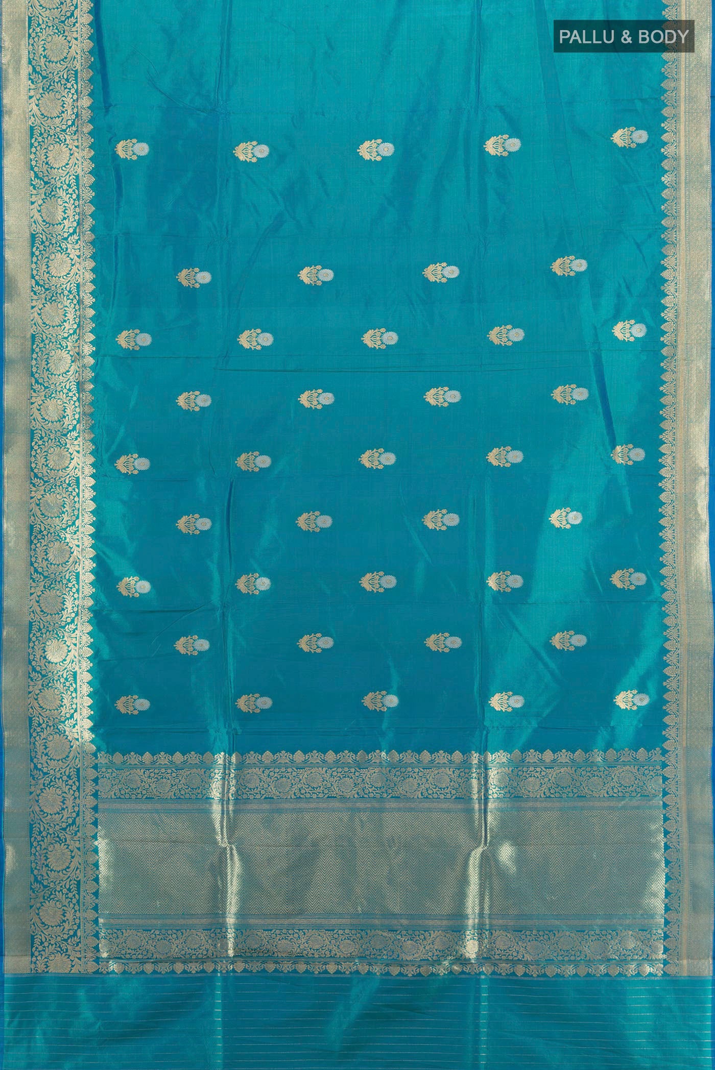 Flat view of Peacock Blue Banarasi Katan Silk Saree with Zari Butta on the body and Zari Border. 
