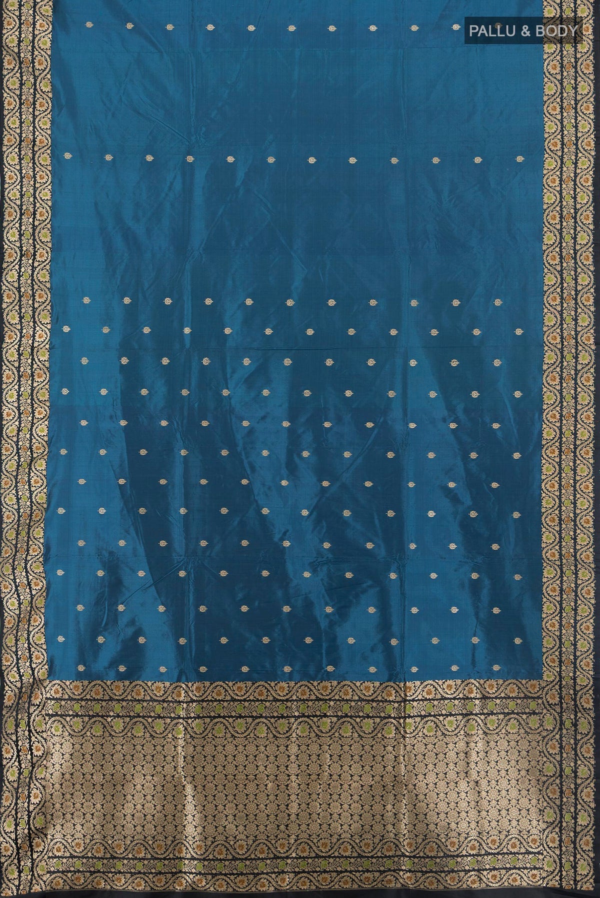 Flat view of Dark Blue Banarasi Katan Silk Saree with Zari Butta on the body and Zari Border. 
