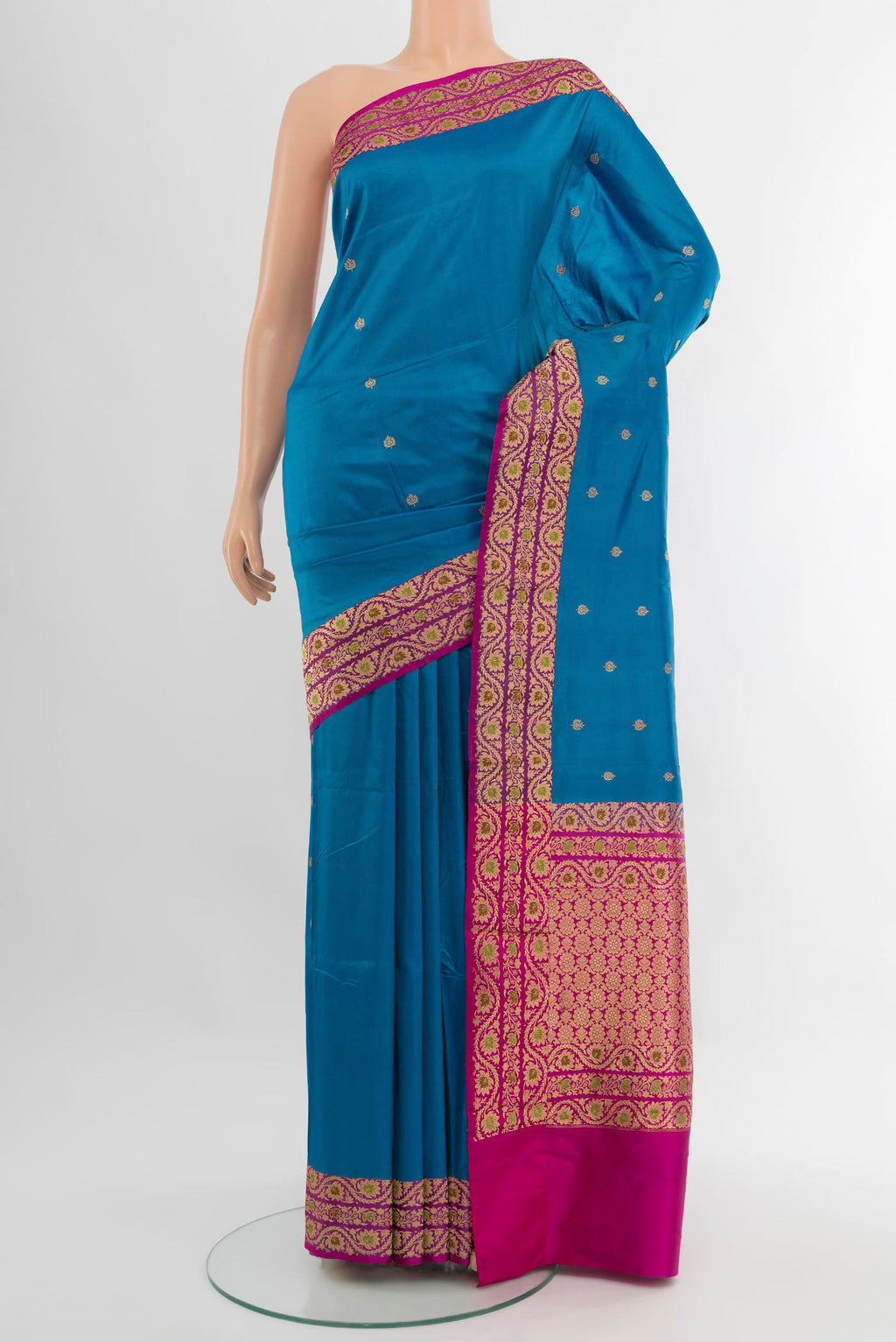 Blue Banarasi Katan Silk Saree with Zari Butta on the body and Zari Border.  displayed on a mannequin