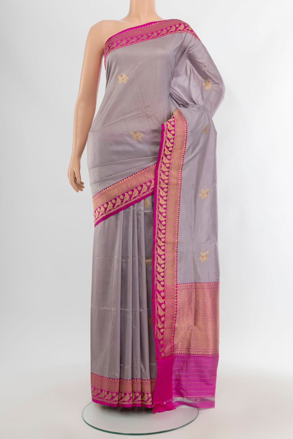 Lilac Banarasi Katan Silk Saree with Zari Butta on the body and Zari Border.  displayed on a mannequin