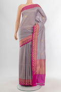 Lilac Banarasi Katan Silk Saree with Zari Butta on the body and Zari Border.  displayed on a mannequin