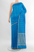 Sky Blue Banarasi Katan Silk Saree with Zari Butta on the body and Zari Border.  displayed on a mannequin